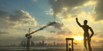 Abu Dhabi skyline at sunset seen past a construction crane