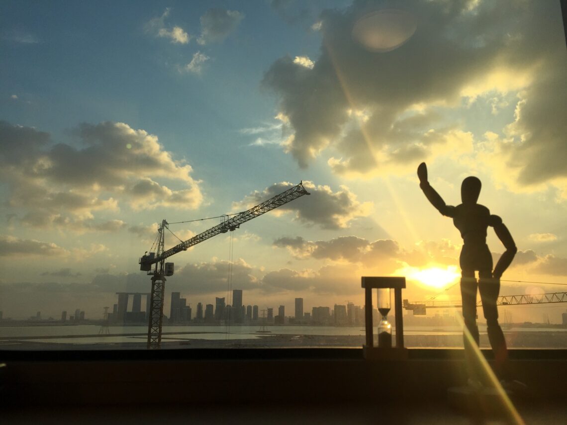 Abu Dhabi skyline at sunset with construction crane