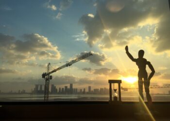 Abu Dhabi skyline at sunset with construction crane