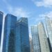Singapore's Marina Bay financial district skyline with DBS and UOB bank towers, illustrating a story about wealthy Chinese individuals relocating wealth to Singapore