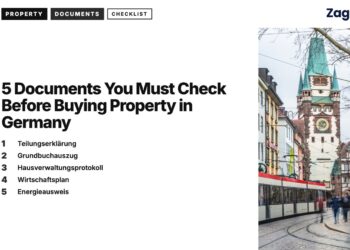 Transport — Tram passing historic gate tower with pedestrians Freiburg, illustrating 5 Documents You Must Check Before Buying Property in Germany