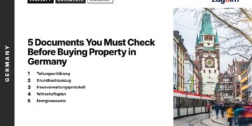 Transport — Tram passing historic gate tower with pedestrians Freiburg, illustrating 5 Documents You Must Check Before Buying Property in Germany