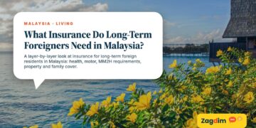Calm sea with flowering bush and distant jetty, illustrating What Insurance Do Long-Term Foreigners Need in Malaysia?