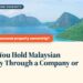 Aerial view of twin island peaks and coral reef, Semporna (Bohey Dulang), illustrating Should You Hold Malaysian Property Through a Company or SPV?