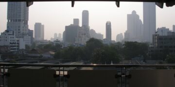Central Bangkok skyline of condominium and office towers seen from a covered balcony