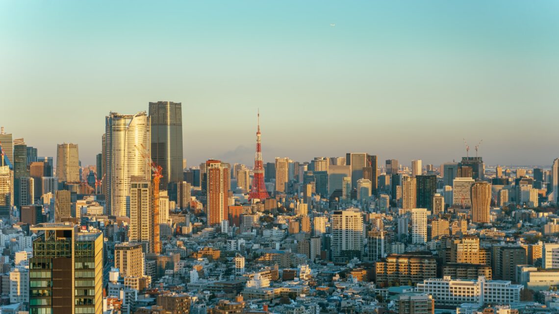 Tokyo skyline at golden hour with Tokyo Tower prominent among the high-rise towers of Minato ward