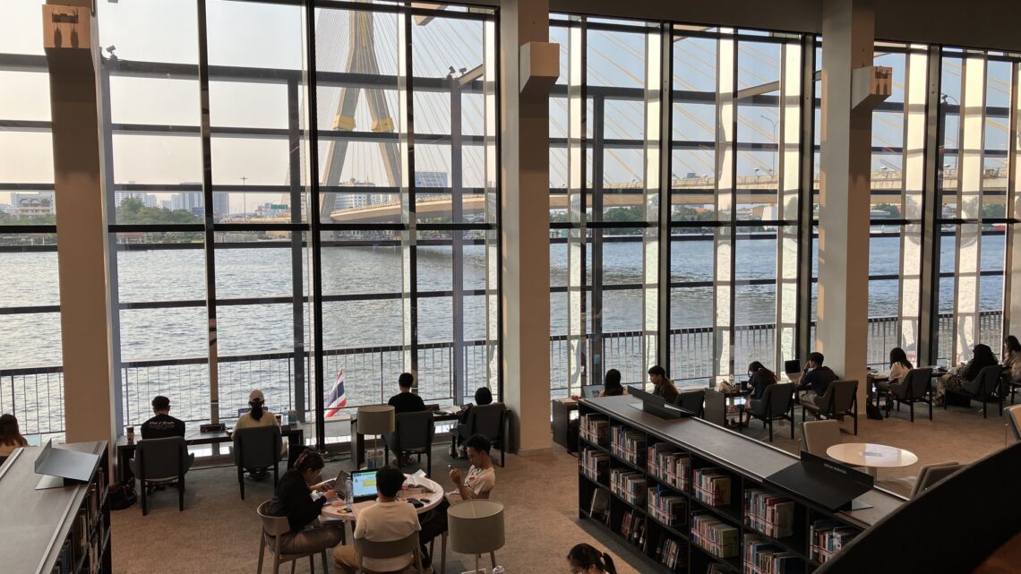 Interior of the Bank of Thailand Learning Center library, overlooking the Chao Phraya River and Rama VIII Bridge