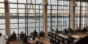 Interior of the Bank of Thailand Learning Center library, overlooking the Chao Phraya River and Rama VIII Bridge