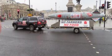 Mock missile trailer reading 'No Farmers No Food' towed through central London during a farmers' inheritance tax protest