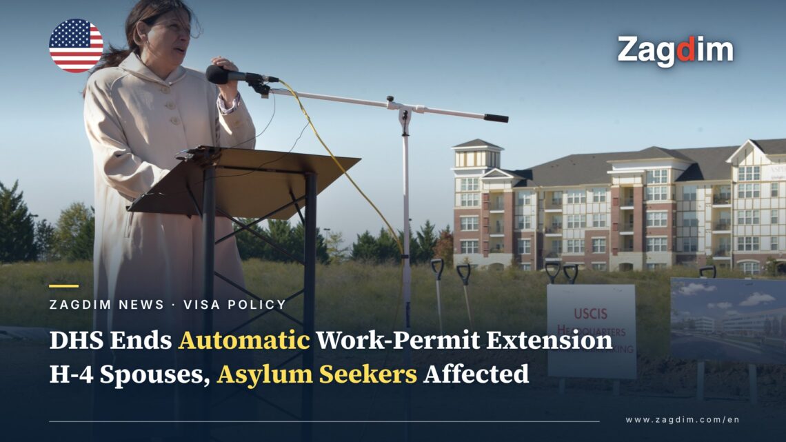 A DHS official speaks at the 2017 USCIS headquarters groundbreaking ceremony in Camp Springs, Maryland, with a 'USCIS HEADQUARTERS Groundbreaking' sign visible, illustrating a story on DHS/USCIS ending automatic work-permit extensions