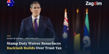 Australian Treasurer Jim Chalmers speaking at a lectern marked Australian Government, with the Australian flag behind him