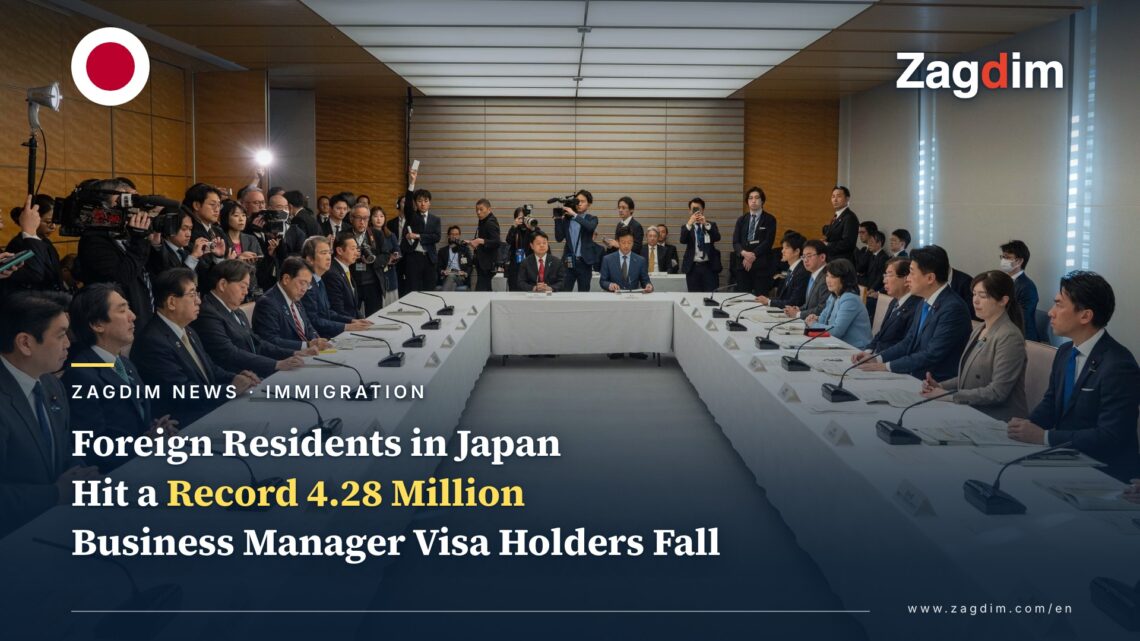 Japanese cabinet ministers seated around a U-shaped table at the January 2026 ministerial council on accepting foreign nationals, with press photographers behind