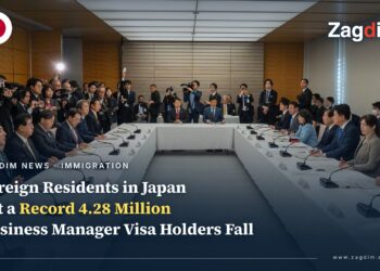 Japanese cabinet ministers seated around a U-shaped table at the January 2026 ministerial council on accepting foreign nationals, with press photographers behind