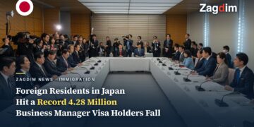 Japanese cabinet ministers seated around a U-shaped table at the January 2026 ministerial council on accepting foreign nationals, with press photographers behind
