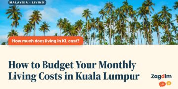 Tall palm trees against a blue sky, illustrating How to Budget Your Monthly Living Costs in Kuala Lumpur