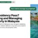 Wooden jetty with pergola over turquoise sea, illustrating No Residency Pass? Visiting and Managing Property in Malaysia