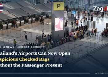 Passengers queue with luggage at the international check-in area of Bangkok's Suvarnabhumi Airport