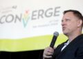 Peter Thiel speaking into a microphone at a public event
