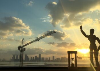 Abu Dhabi skyline at sunset seen past a construction crane