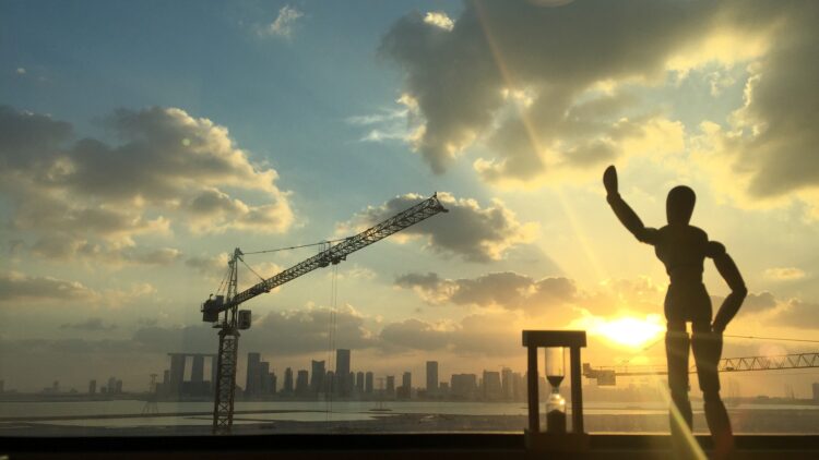 Abu Dhabi skyline at sunset seen past a construction crane