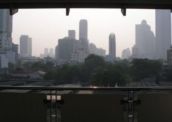 Central Bangkok skyline of condominium and office towers seen from a covered balcony