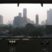 Central Bangkok skyline of condominium and office towers seen from a covered balcony