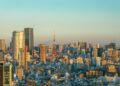 Tokyo skyline at golden hour with Tokyo Tower prominent among the high-rise towers of Minato ward