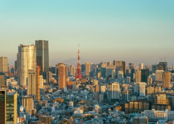 Tokyo skyline at golden hour with Tokyo Tower prominent among the high-rise towers of Minato ward