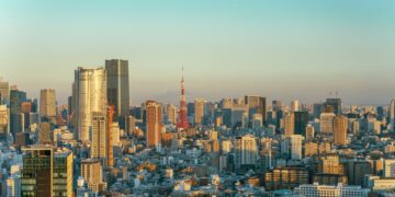Tokyo skyline at golden hour with Tokyo Tower prominent among the high-rise towers of Minato ward