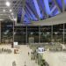 Interior of Suvarnabhumi International Airport's main terminal hall in Bangkok, with check-in counters and travelers