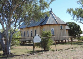 Small timber Anglican church in the regional Queensland outback town of Aramac, one of the towns named in the story's regional-yields example