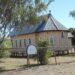 Small timber Anglican church in the regional Queensland outback town of Aramac, one of the towns named in the story's regional-yields example