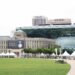 Seoul City Hall's distinctive glass-wave facade rising behind the old stone city hall building, with Seoul Plaza in front