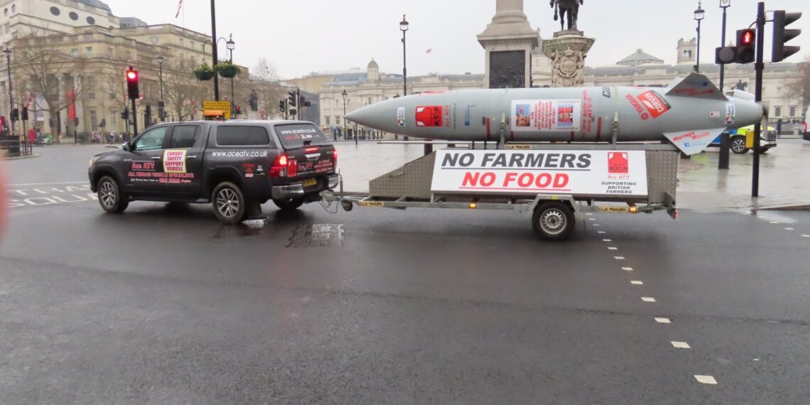 Mock missile trailer reading 'No Farmers No Food' towed through central London during a farmers' inheritance tax protest