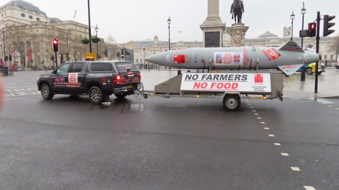 Mock missile trailer reading 'No Farmers No Food' towed through central London during a farmers' inheritance tax protest