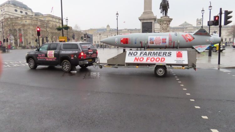 Mock missile trailer reading 'No Farmers No Food' towed through central London during a farmers' inheritance tax protest